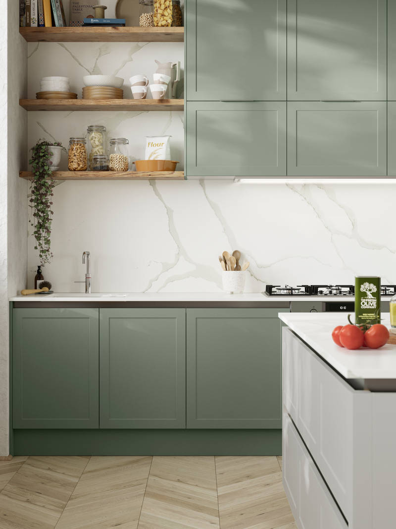 Integra Dunham from Magnet is a handleless shaker frontal, here shown in kitchen with kitchen island and wall cabinets in shades Eucalyptus and Washed Cotton, with a white marbled worktop and matching splashback with wood open wall shelves..