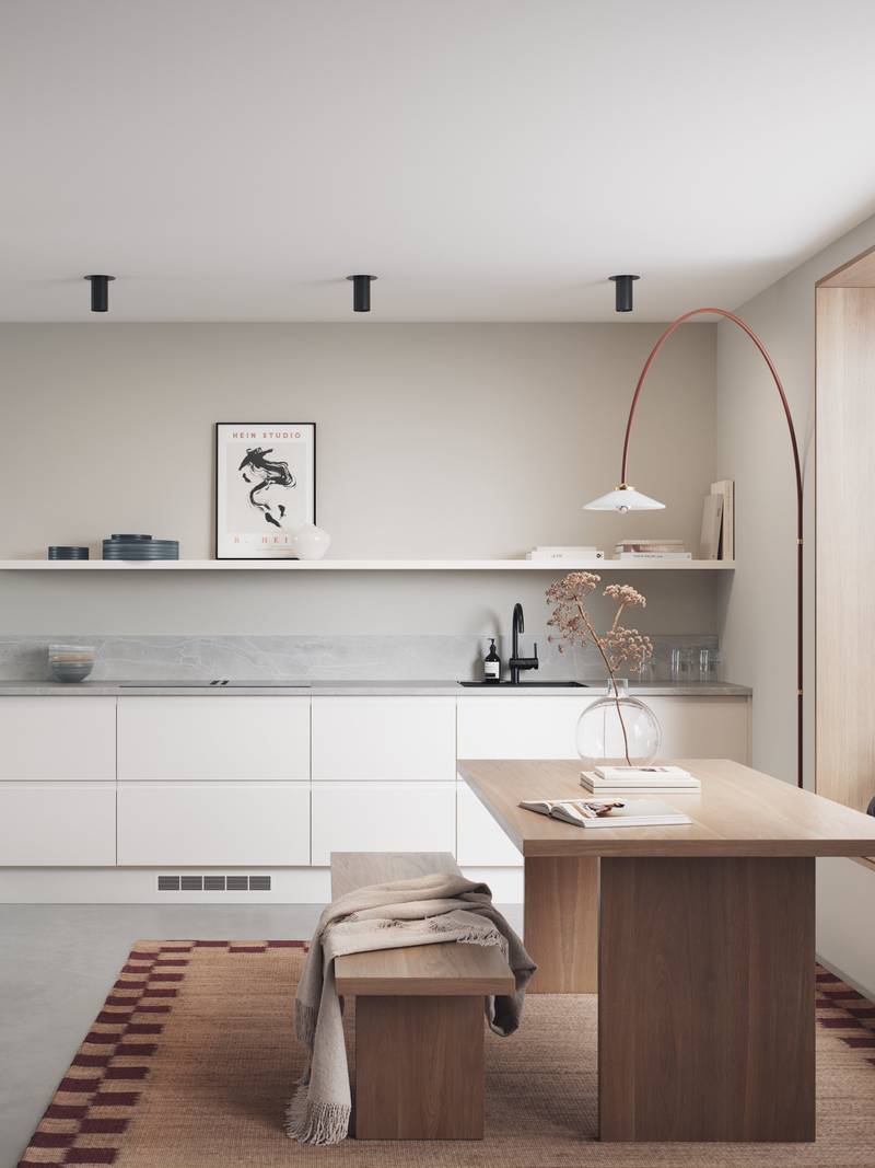 Hvit kjøkken med integrerte grep, før en innredninsløsning som er lineær og grafisk velskapt, med tre spisebord och sittbænk