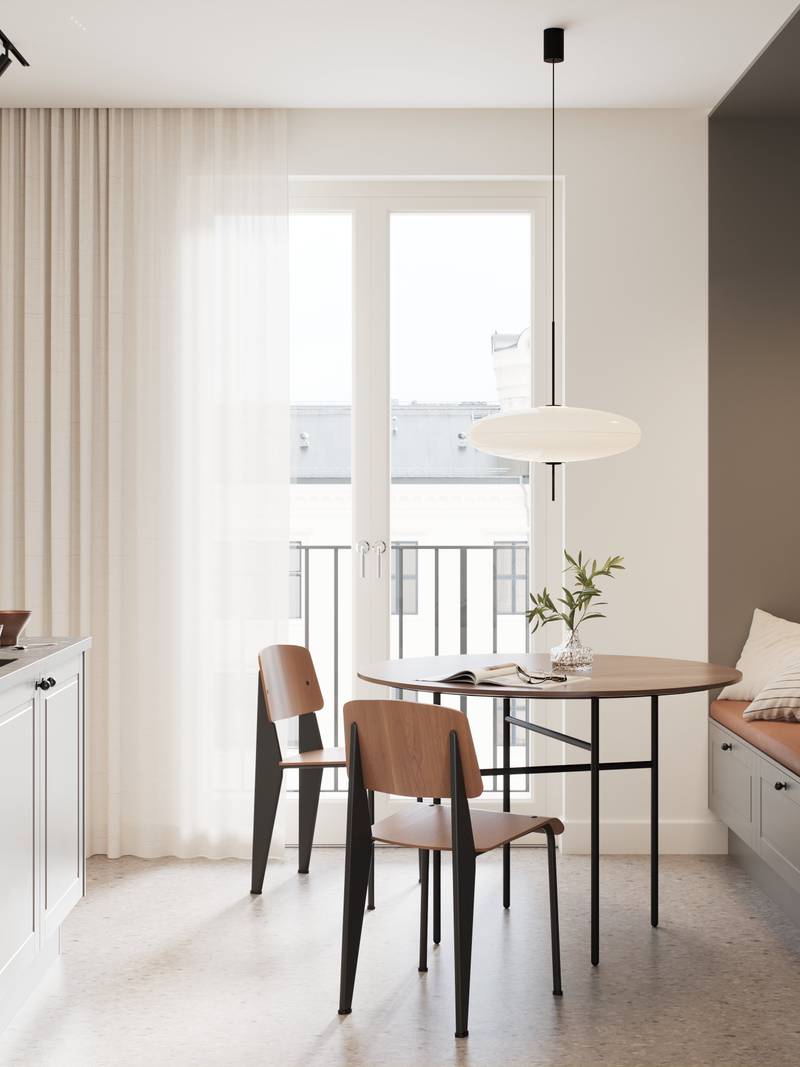 Ajaton ja moderni keskiharmaa keittiö, jossa jyrsityt peiliovet, jotka antavat keittiöön klassisia yksityiskohtia olematta rustiikkia, mustat nupit, musta hana ja musta pesuallas.