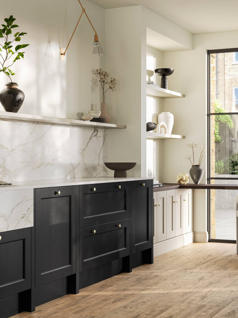 Traditional Shaker-style tactile woodgrain Ludlow Sumi Black kitchen with kitchen island, light and airy with brass accessories, marbled white and grey worktop, home office area by full height windows and Amtico oak stripwood vinyl flooring.