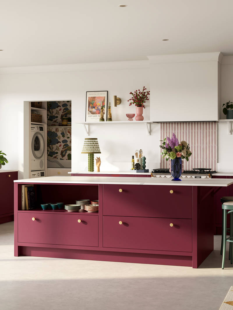 Modern slab front Soho Morello kitchen, kitchen island with rattan bar stools at breakfast bar, Bianco calacatta worktop and upstand, brass knobs and open shelf in kitchen island holding eclectic eramics, utility room with matching Soho cabinetry in the shade  Shell.