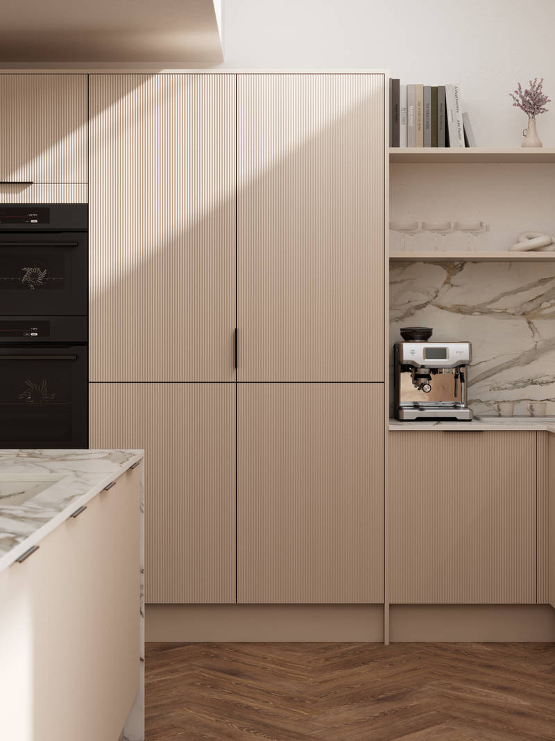 Fluted front kitchen Reed from Magnet in light warm neutral shade Shell, with a marbled splashback and worktop, brass tap in kitchen island sink