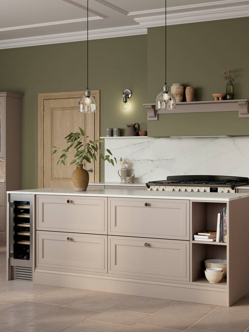 Shaker style painted wood grain Bewdley kitchen in neutral shade Cornish Clay, tall cabinets and kitchen island with marbled worktop and matching backsplash, wine cooler in the kitchen island and gas range cooker.