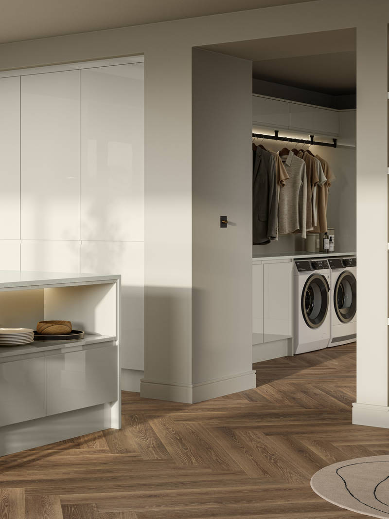Open plan contemporary Luna Gloss kitchen with a kitchen island, breakfast bar, tall cabinetry, matching open shelves in living room with natural material decorations and utility room with integrated washing machine and tumble dryer, Amtico smouldering oak parquet flooring.