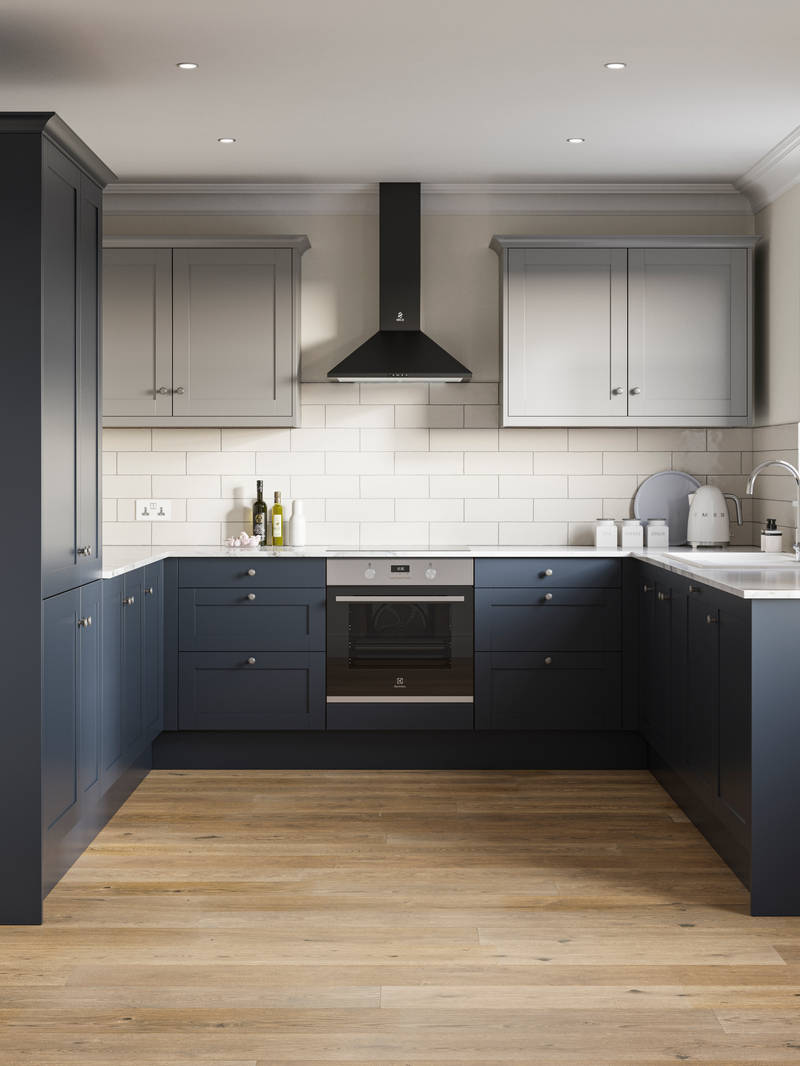 Tatton kitchen from Magnet, in U shape, with tall cabinets and matching kitchen counter cabinetry in dark blue shade Midnight paired with light grey wall cabinets over countertops, white worktop.