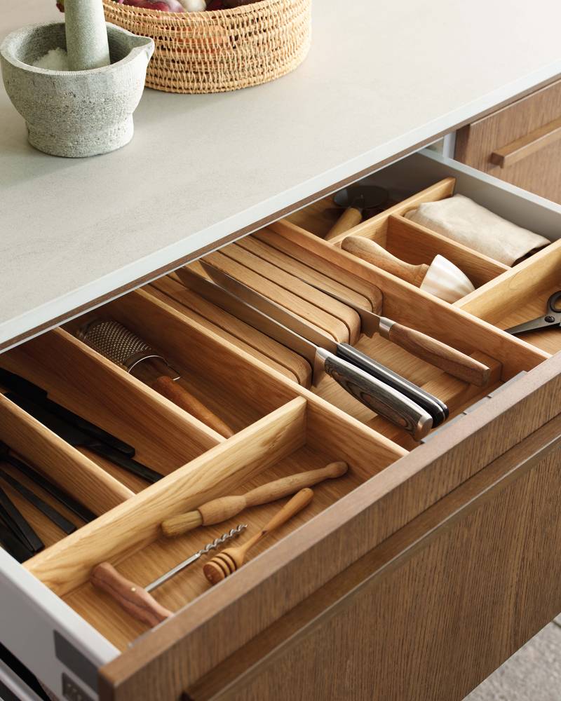 Opened drawer with oak inserts in Nordic Nature kitchen from Magnet