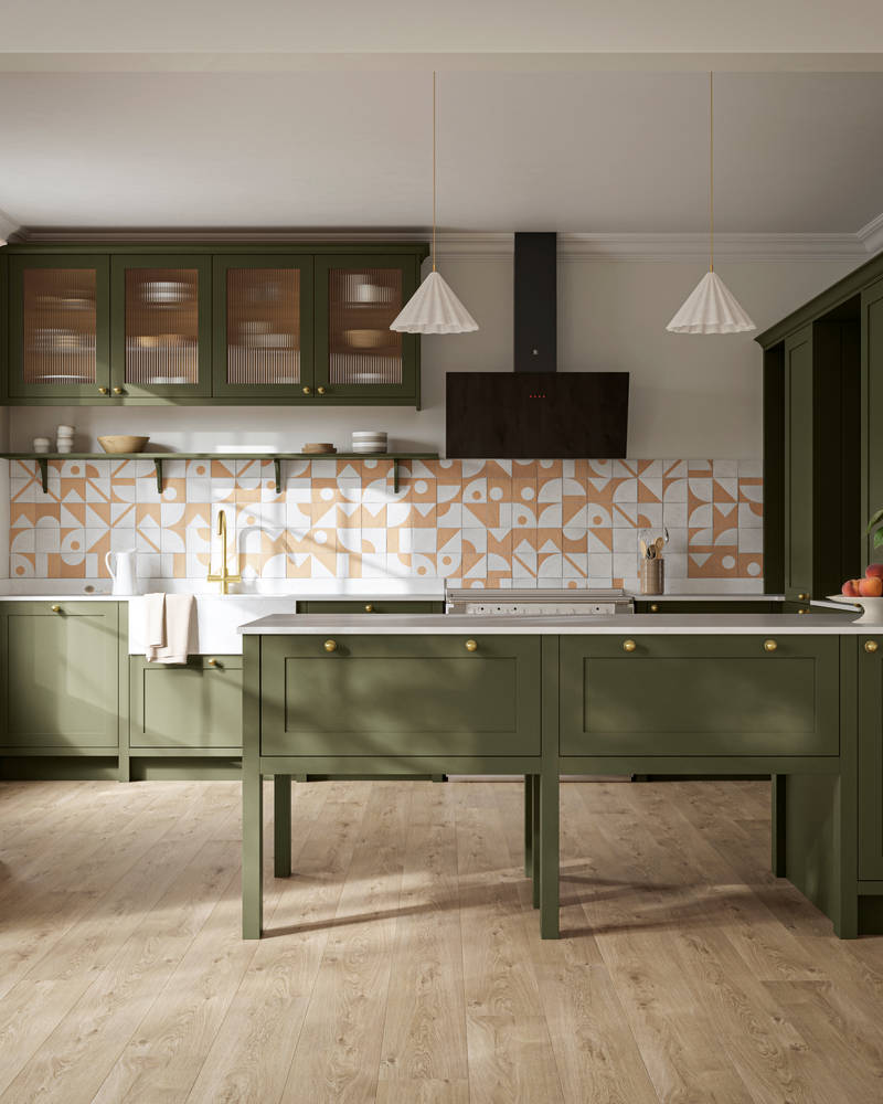 Premium Shaker kitchen Wardley Tailored green with traditional detailing, brass accessories, fluted glass wall vitrine cabinets, standalone Wardley Chalk Blush pantry, Classic Flint Grey oiled oak engineered wood flooring.