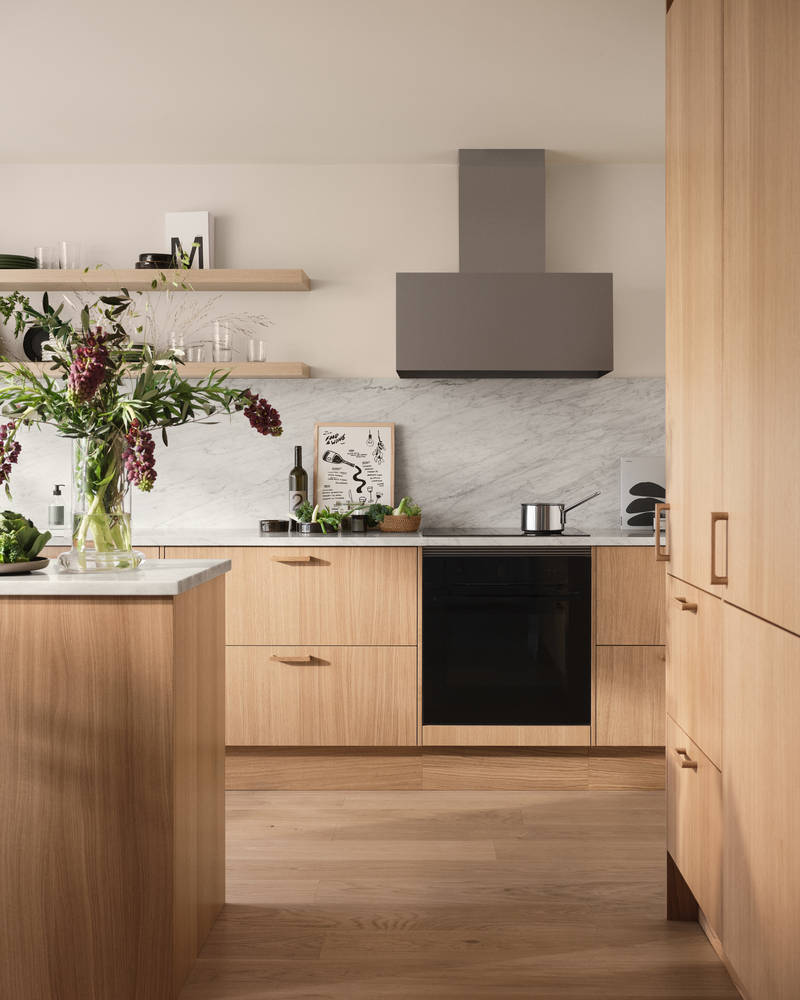 Siri Barjes kök Ekbacken från Marbodal, med marmorbänkskiva, fläkt från Røros, köksö och högskåp med ekluckor.