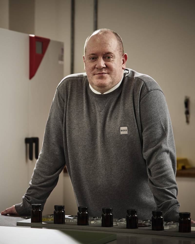 Magnet product expert Charlie Allan, pictured in our kitchen cabinet testing lab, with quality testing equipment and machinery in the background.