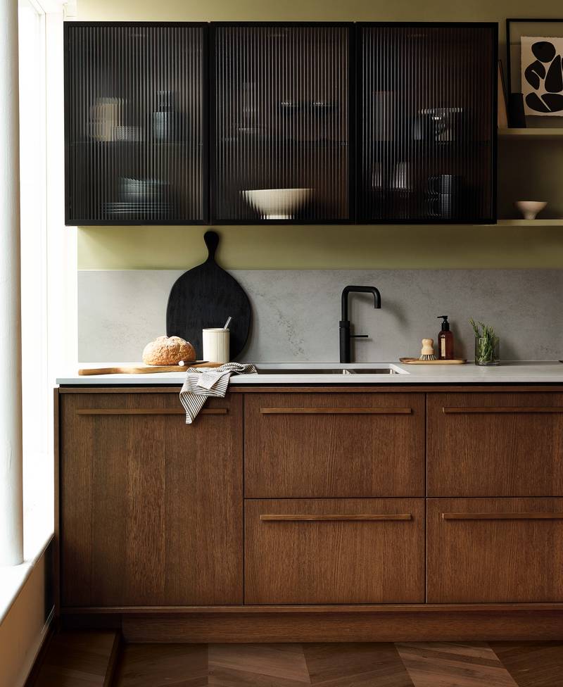 Magnet's kitchen Nordic Nature, with oak cabinetry and display cabinets with fluted glass.
