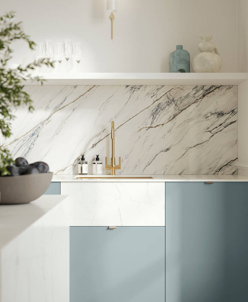 Soho Duck Blue kitchen from Magnet with white marble splashblack, paired beautifully with a bright brass tap and sink.