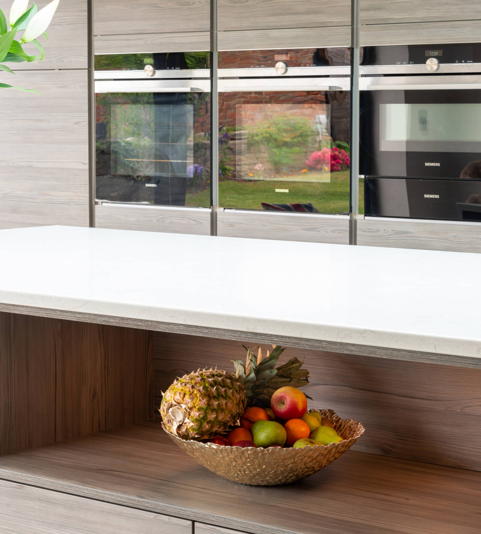 Close-up of fruit bowl in open shelf under the counter in kitchen island
