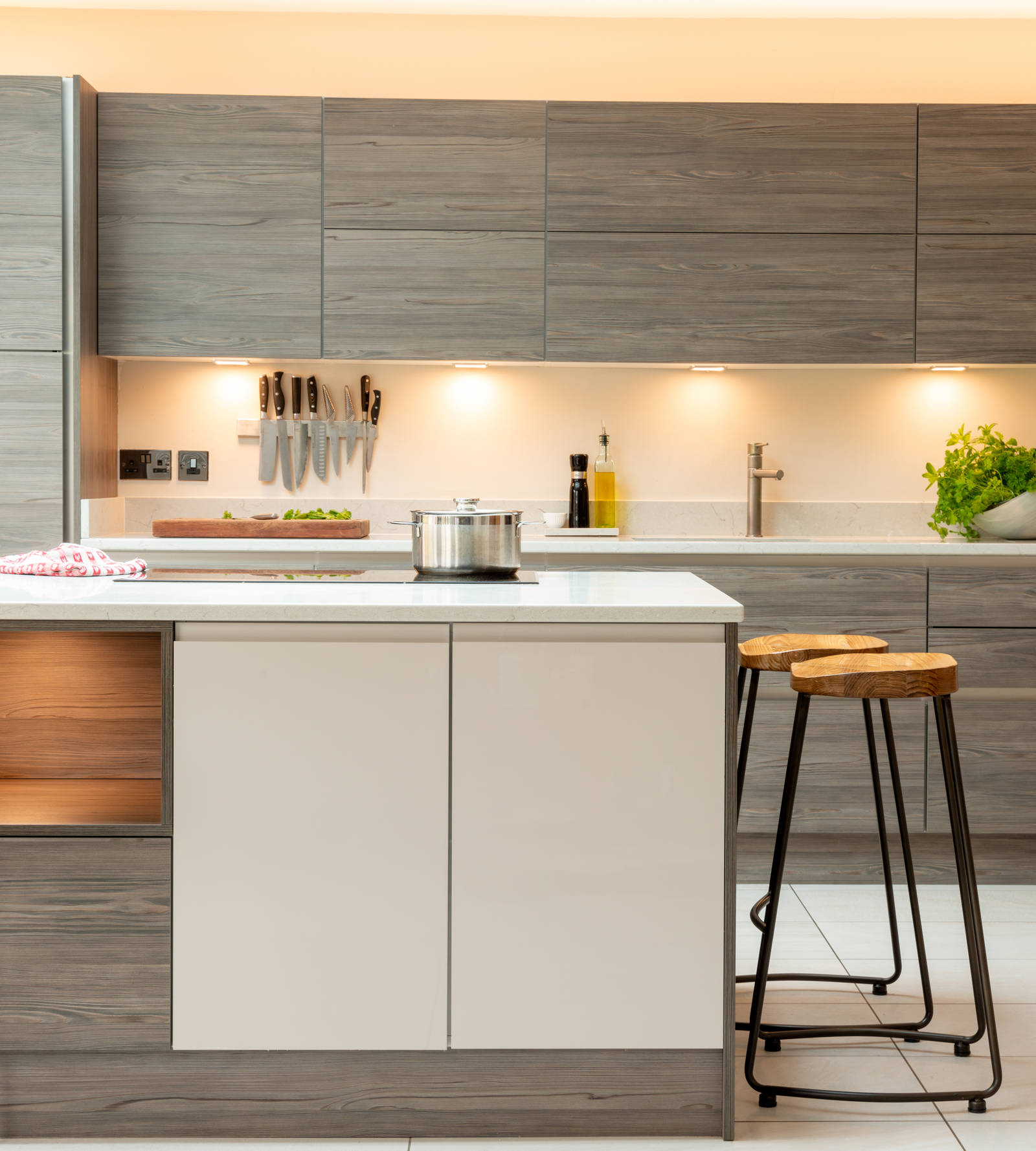 View of light Luna Cashmere kitchen cabinetry in Integra Ascoli Fleetwood Graphite.