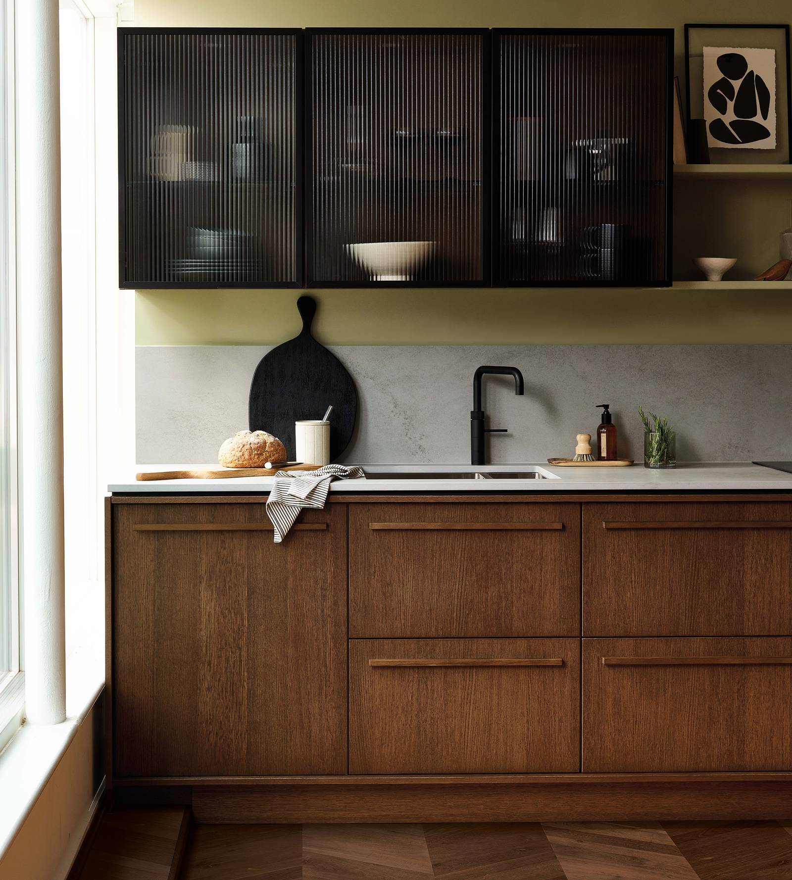 Magnet's kitchen Nordic Nature, with oak cabinetry and display cabinets with fluted glass.