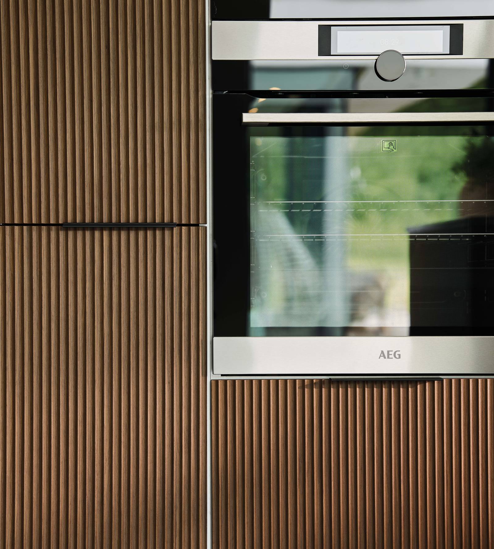 An AEG oven integrated in a Nordic Nature fluted oak kitchen