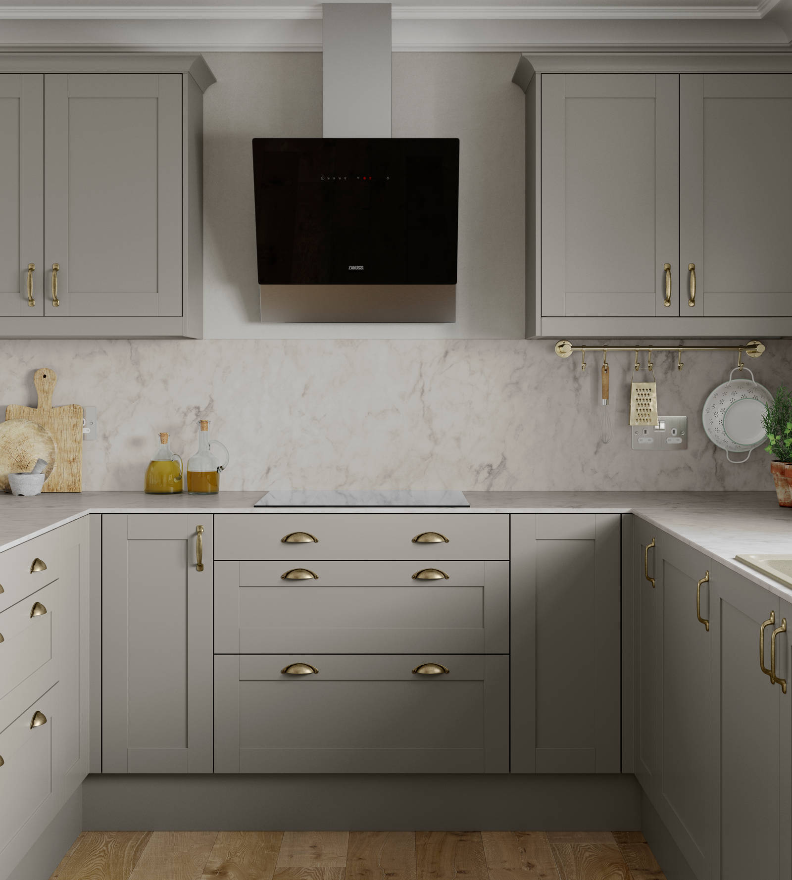 U-shape Tatton kitchen from Magnet in the shade Pebble, brass handles and accessories and a light marbled worktop with matching splashback.