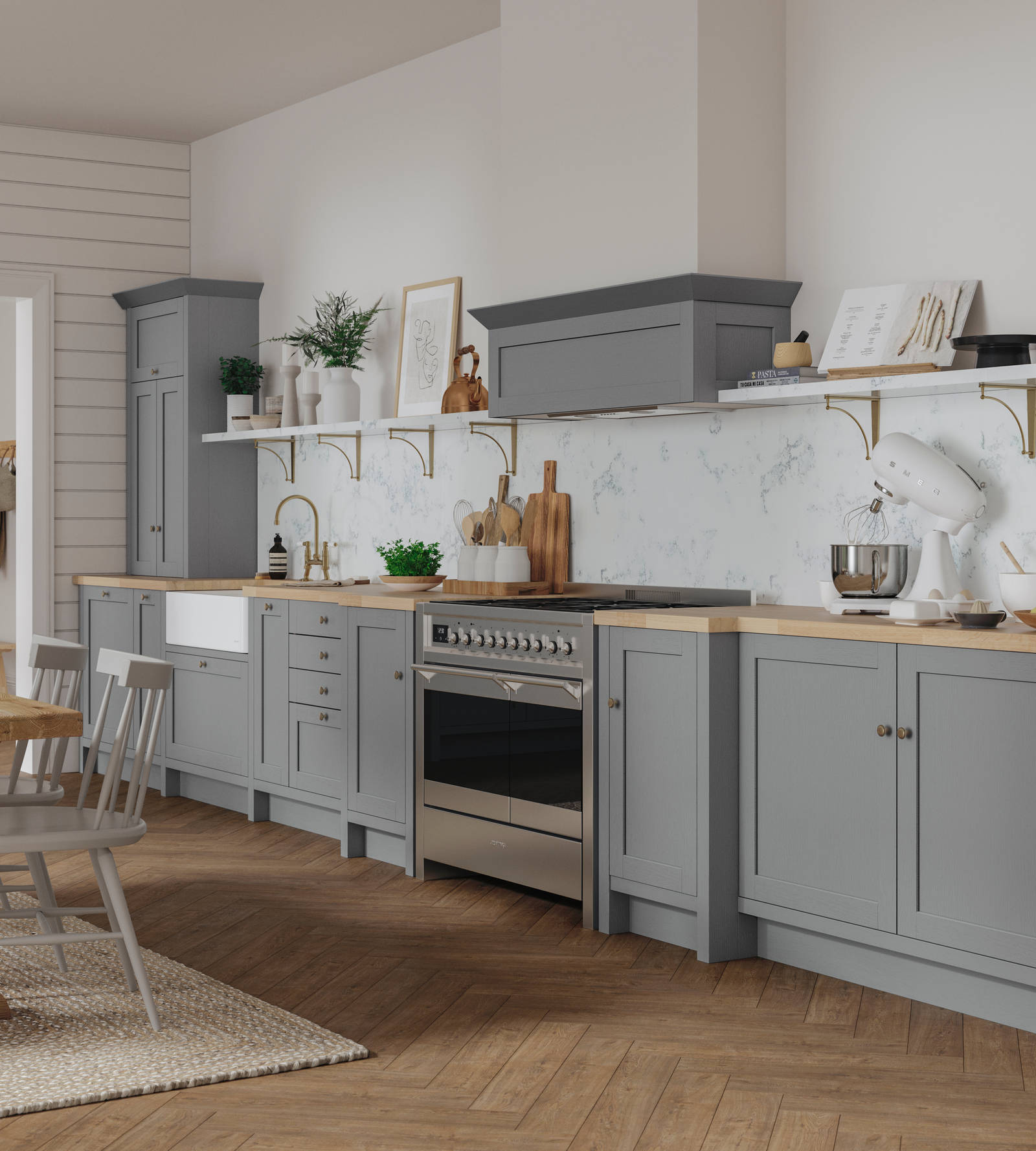 A grey Shaker kitchen seen with a wooden dining table and accessorised with plants.