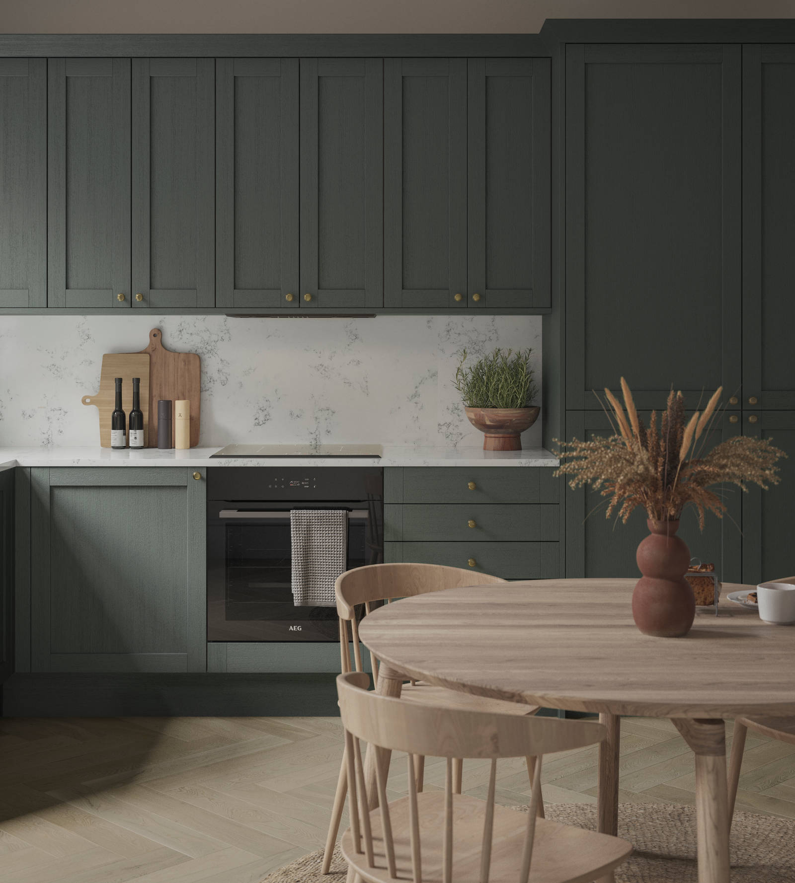 A Shaker kitchen with dark green cabinets and a wooden table.