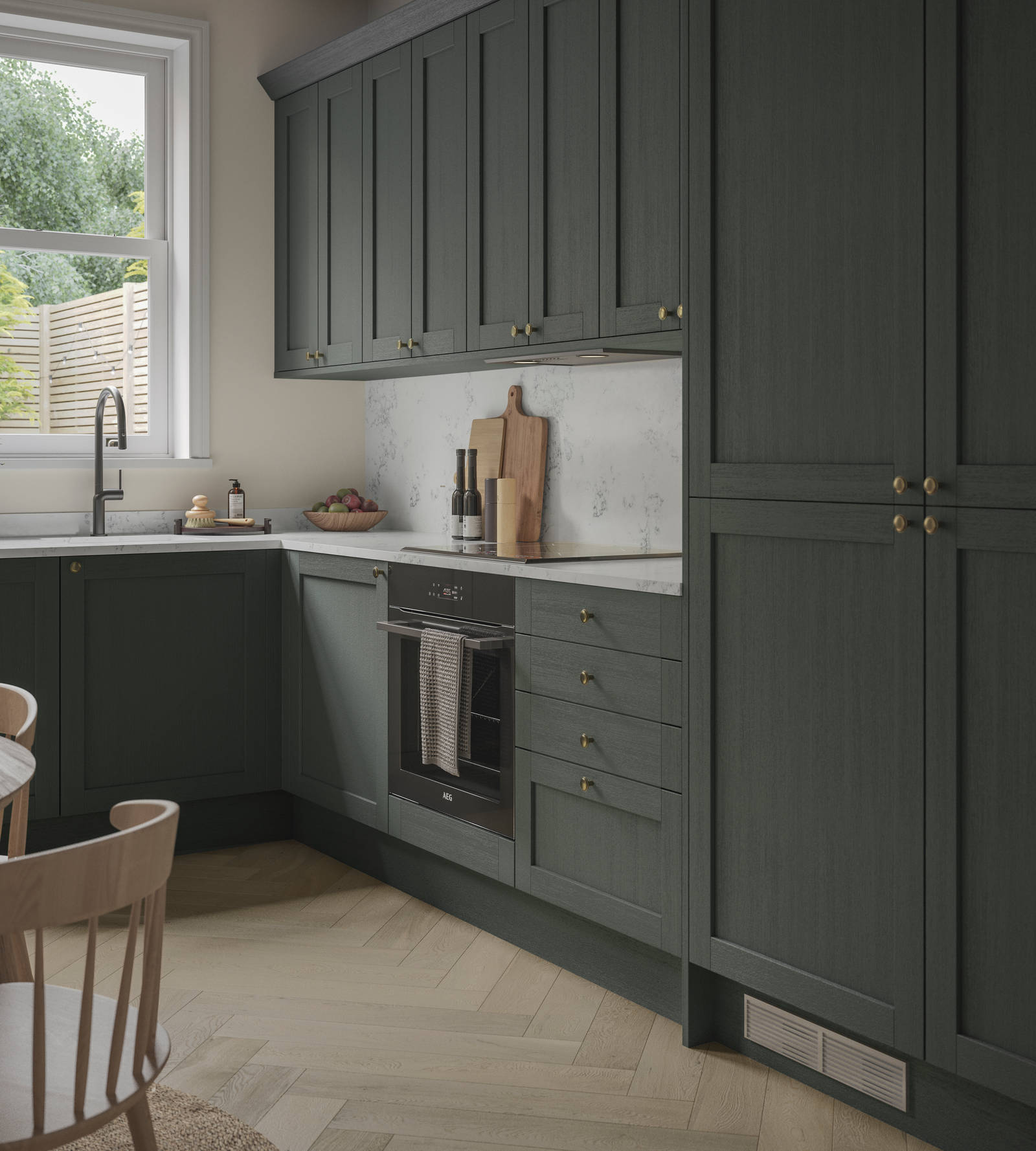 A contemporary Shaker kitchen in Ambleside with dark green cabinets and a wooden table.