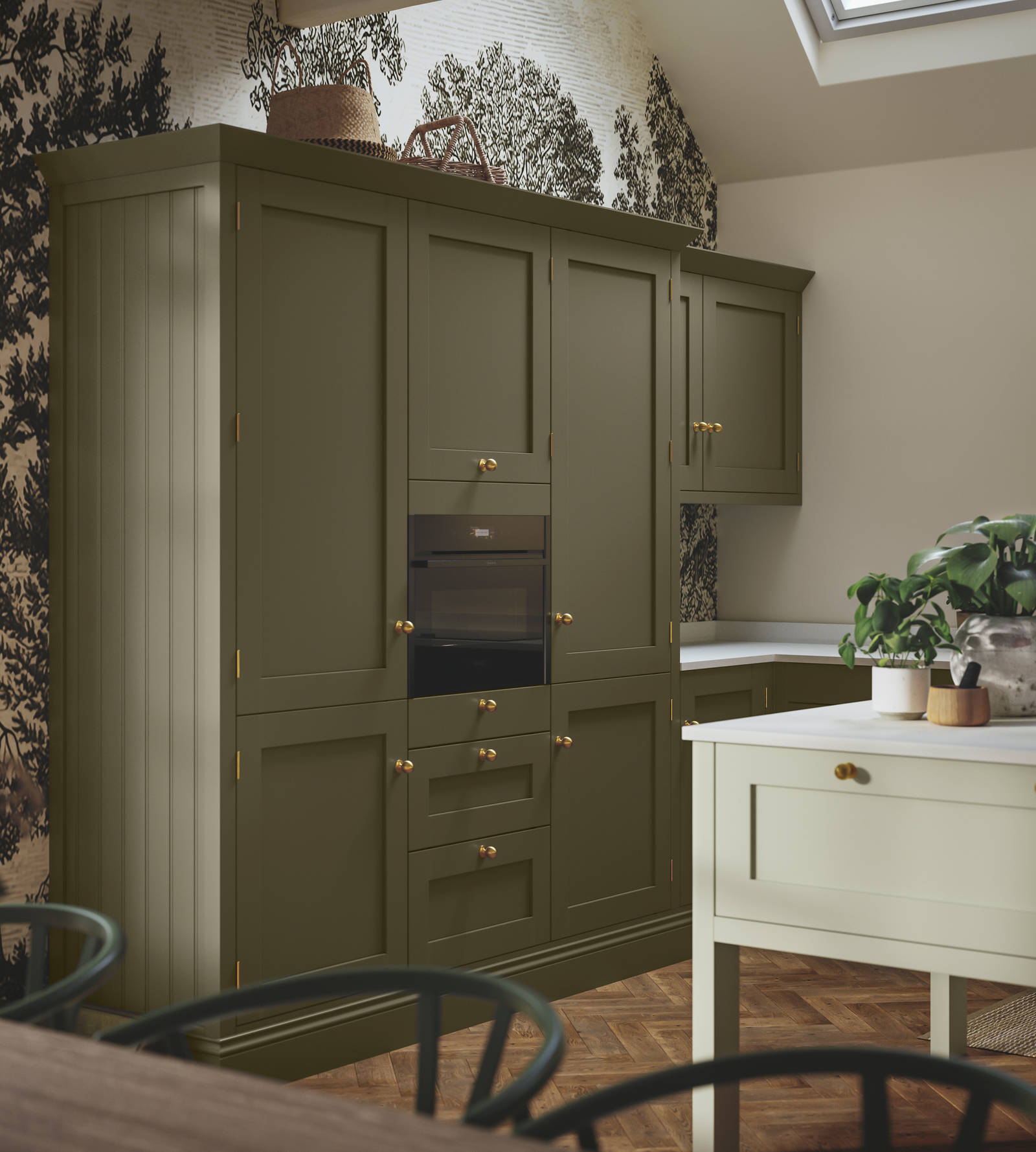 Tall Wardley Arboretum kitchen cabinets and a lighter kitchen island, all with brass details.