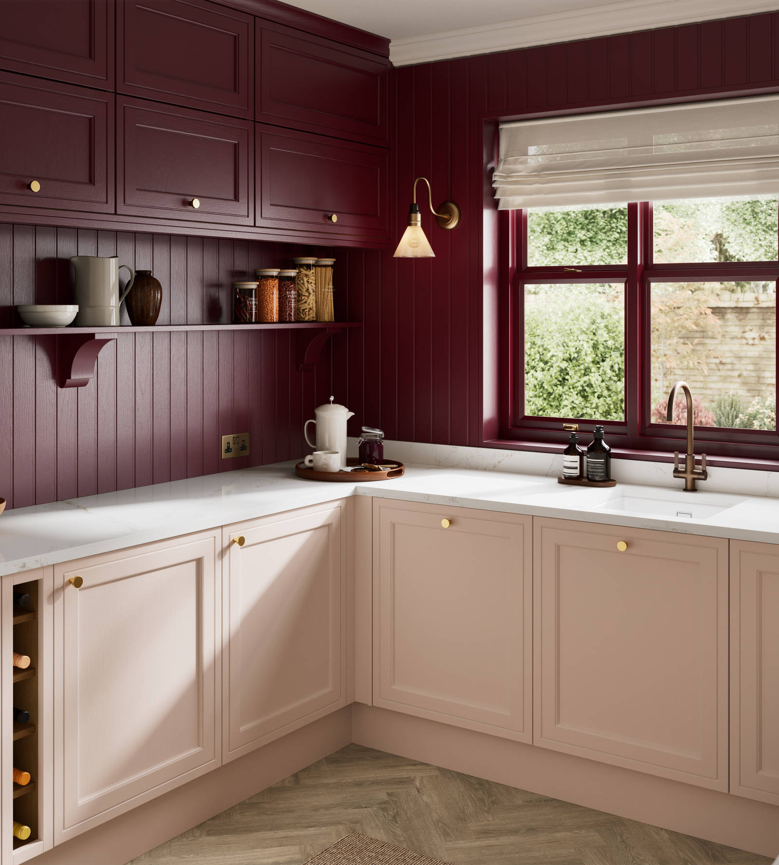 Painted wood grain Shaker style Bewdley kitchen with cabinets in light pink shade Chalk Blush, marbled worktop, brass knobs, red Morello wall-mounted cabinets with matching shelves and wall panel, built- in wine storage.