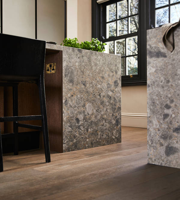 Floor level view of kitchen island seating area with a black tall chair