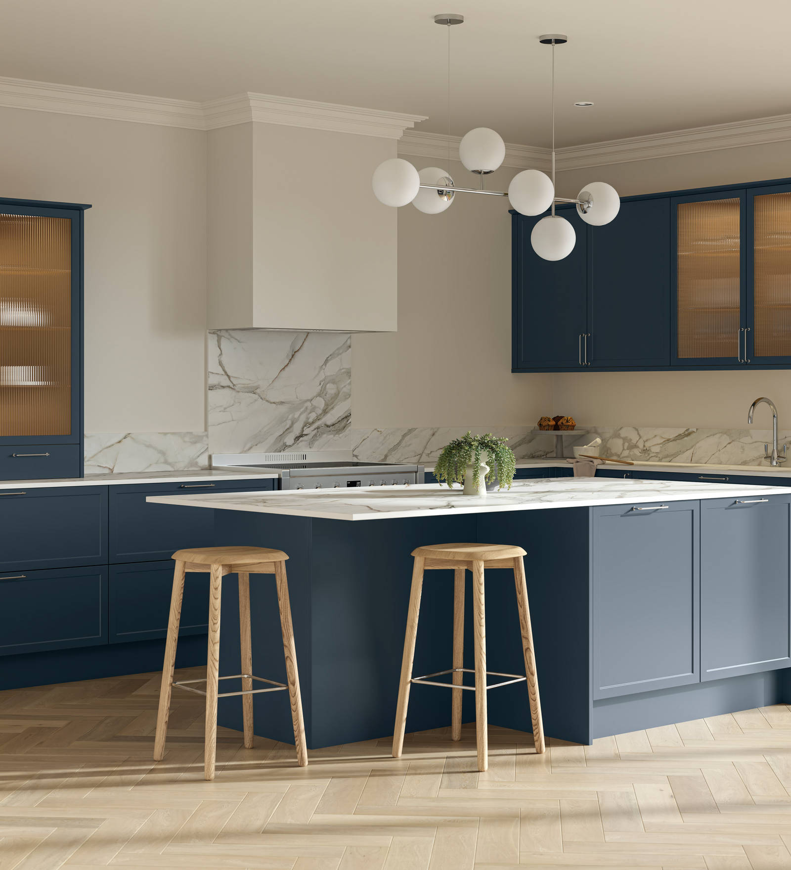 Modern Shaker kitchen Brunswick Voyage blue with white and grey marbled worktop and matching splashback, a kitchen island with breakfast bar and vitrine cabinets with fluted glass, and light wood herringbone flooring.