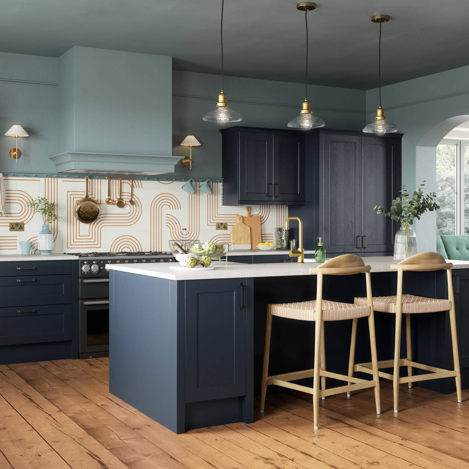 Modern country-style Ludlow kitchen in dark blue shade Midnight, with lighter blue walls, wooden floors and wooden barstools by kitchen island.