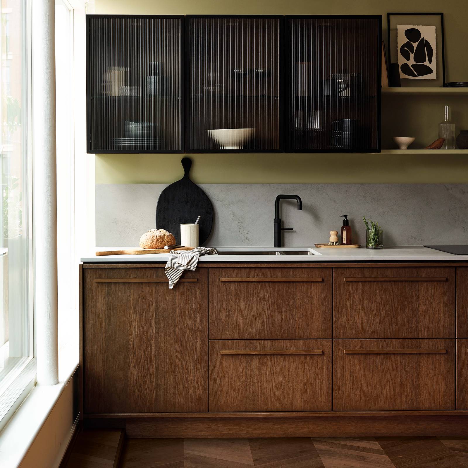 Magnet's kitchen Nordic Nature, with oak cabinetry and display cabinets with fluted glass.