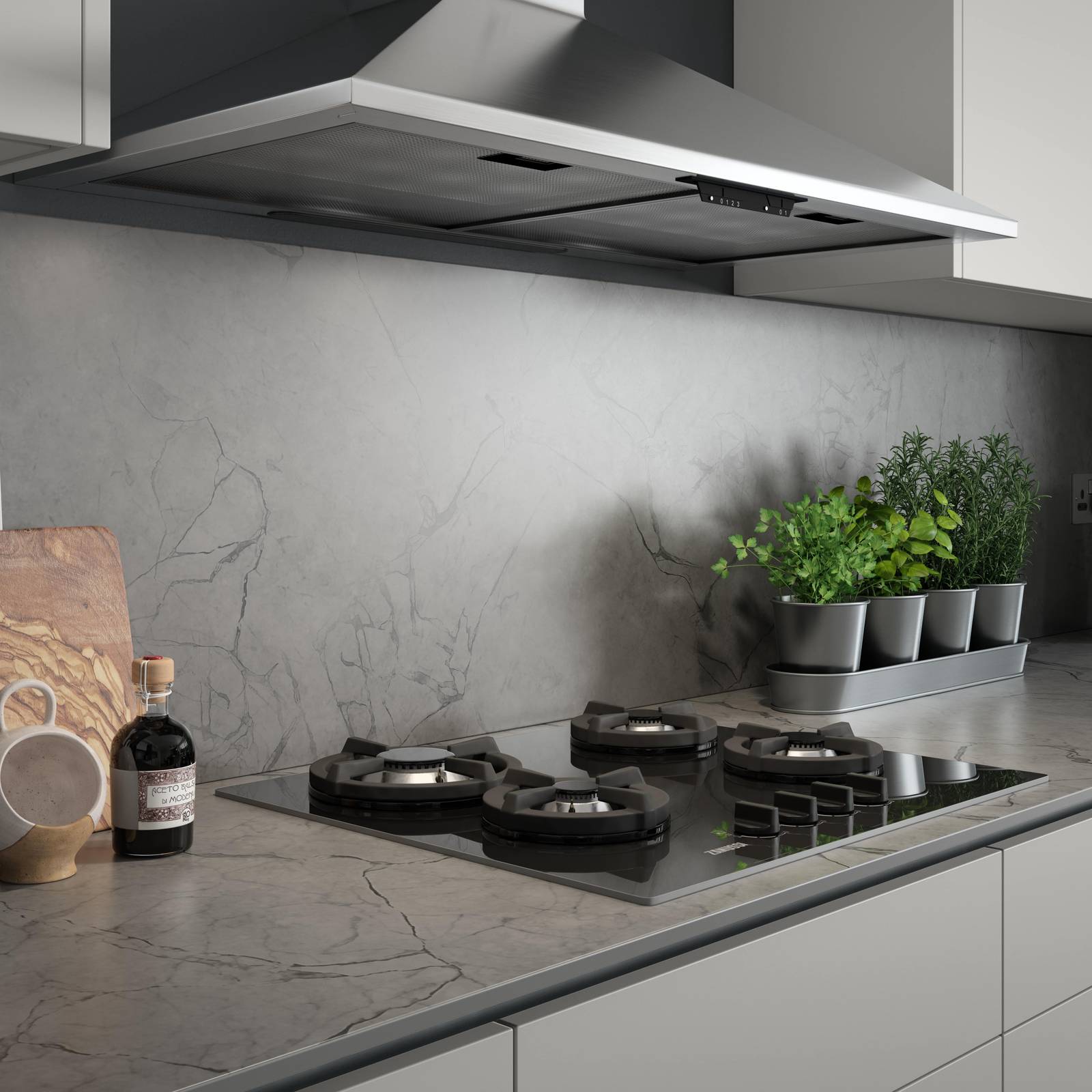 Close-up of hob on a grey and black marbled worktop and splashback in kitchen Integra Nova Grey by Magnet.