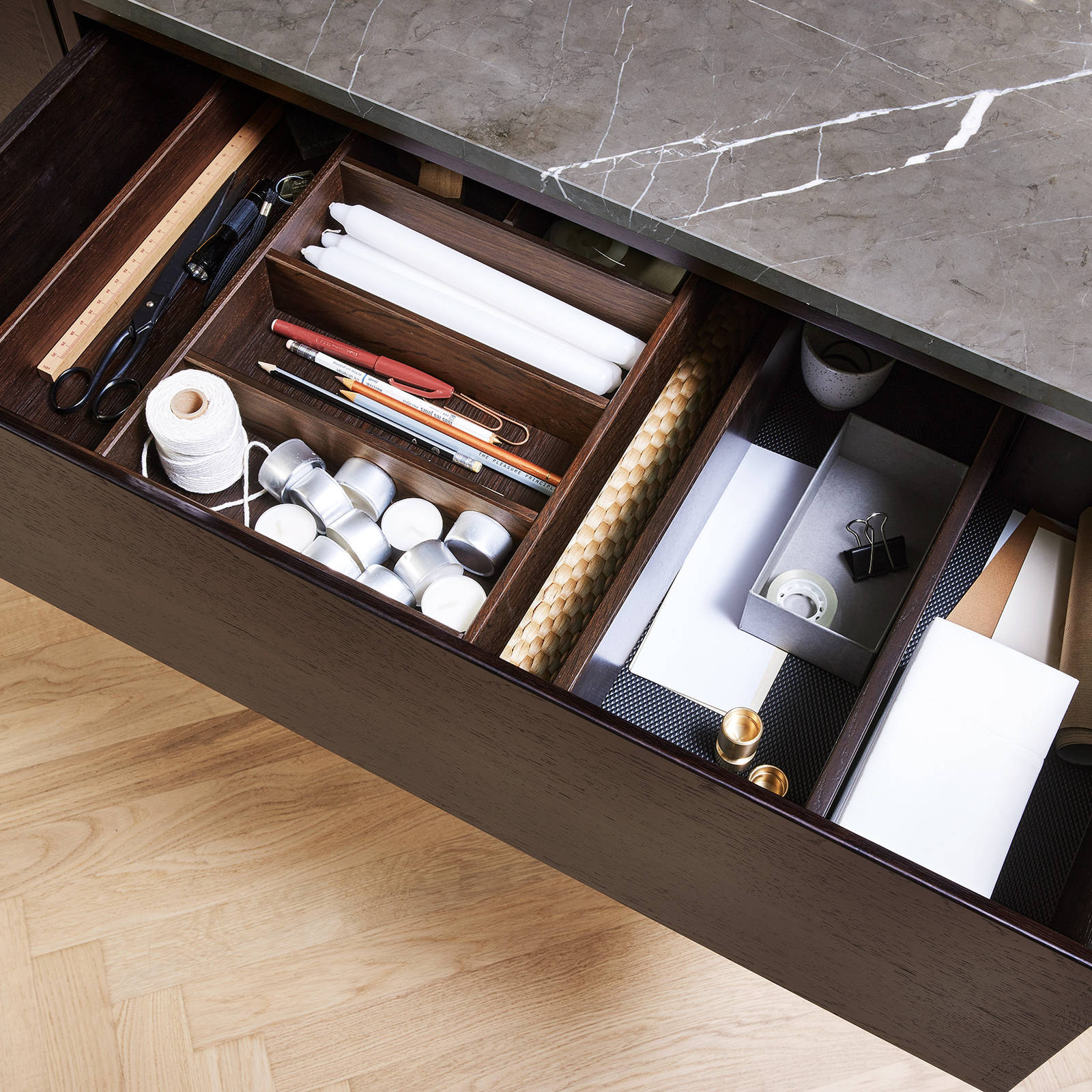 Inner tray, which can be worn from side to side, provides collection for the small items in the drawer