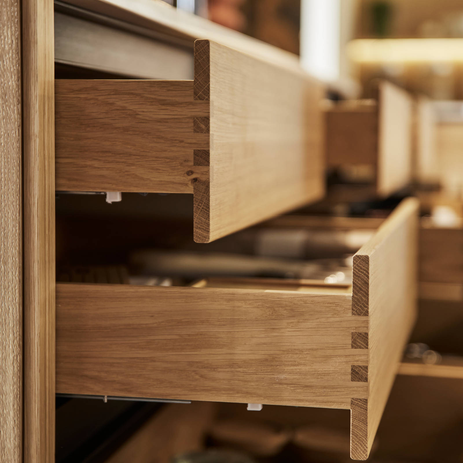 Close-up of opened oak drawers in Nordic Craft kitchen island.
