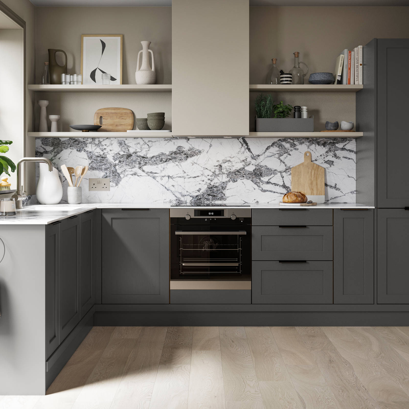 A dark grey Shaker kitchen with Charcoals cabinetry, paired with marble splashback and stylish black handles.