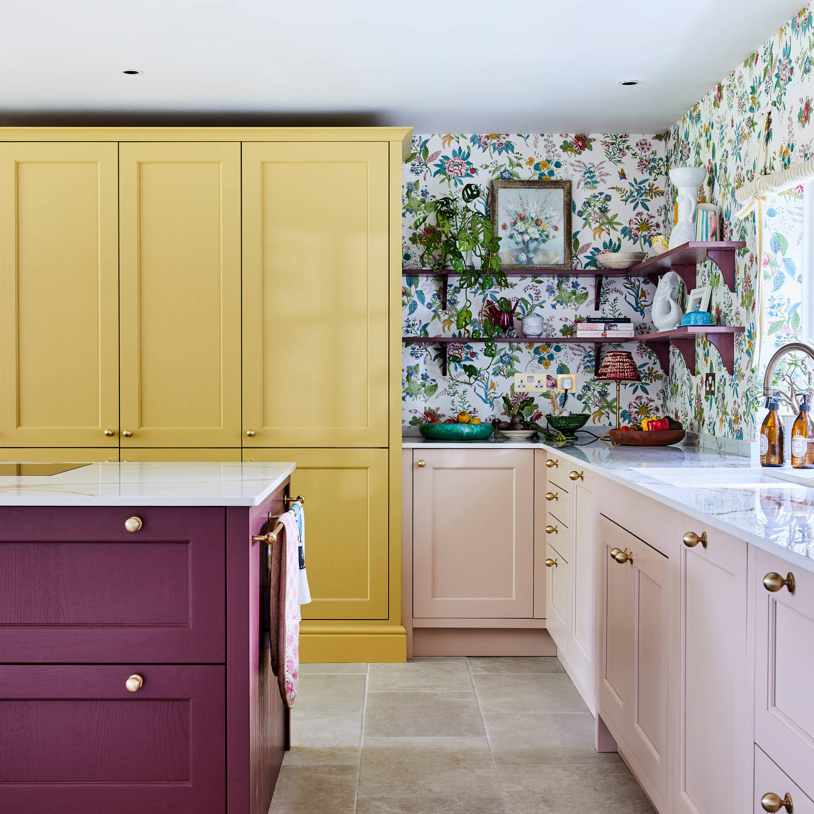 Wide image of sink, kitchen island and pantry larder. Ludlow cabinetry from Magnet in colours Burlington Red, Chalk blush and Harvest in Heritage classic with a contemporary twist.