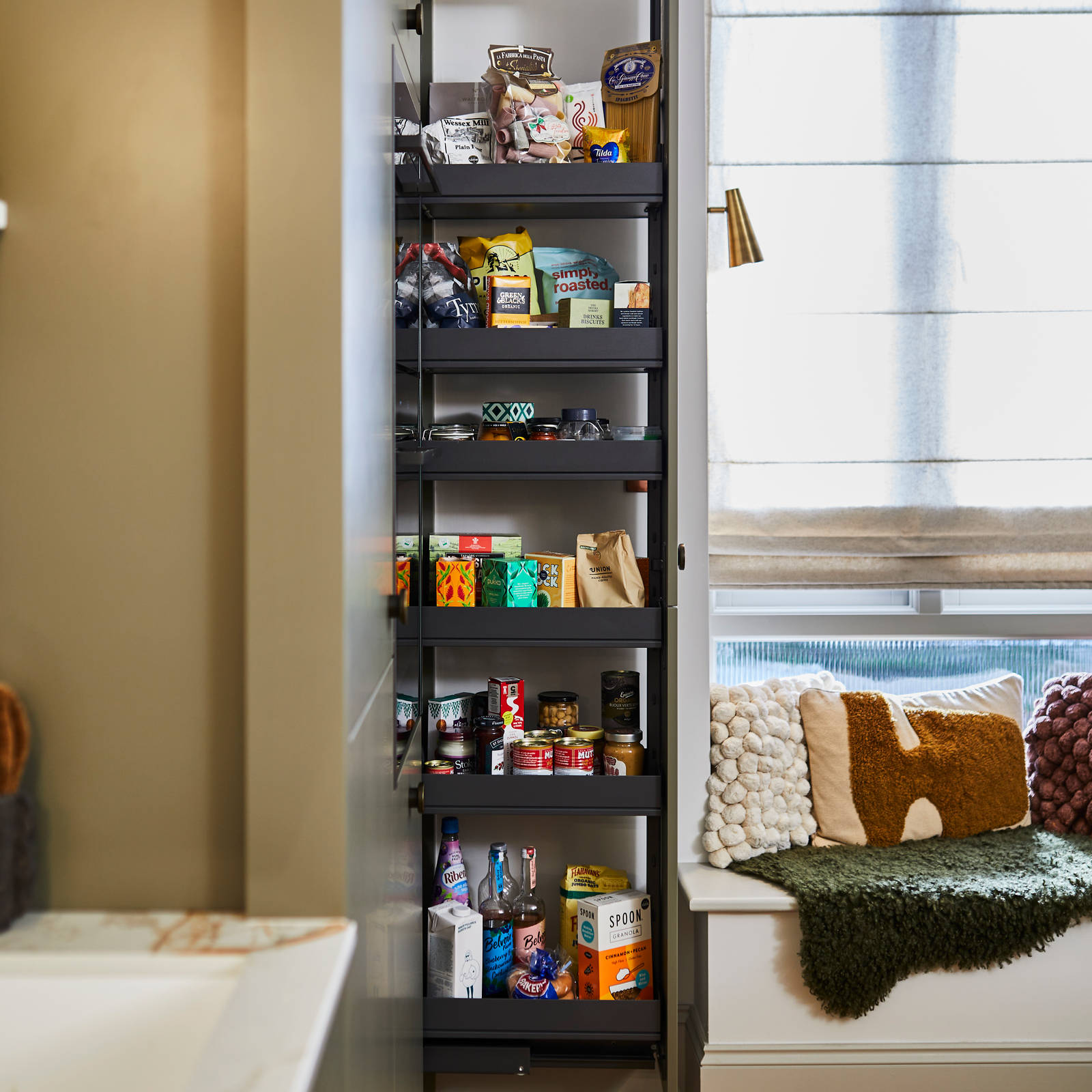 Pulled out shelves in tall cabinet modern slab Soho cabinets in the Balmoral colour, a soft beige green tone