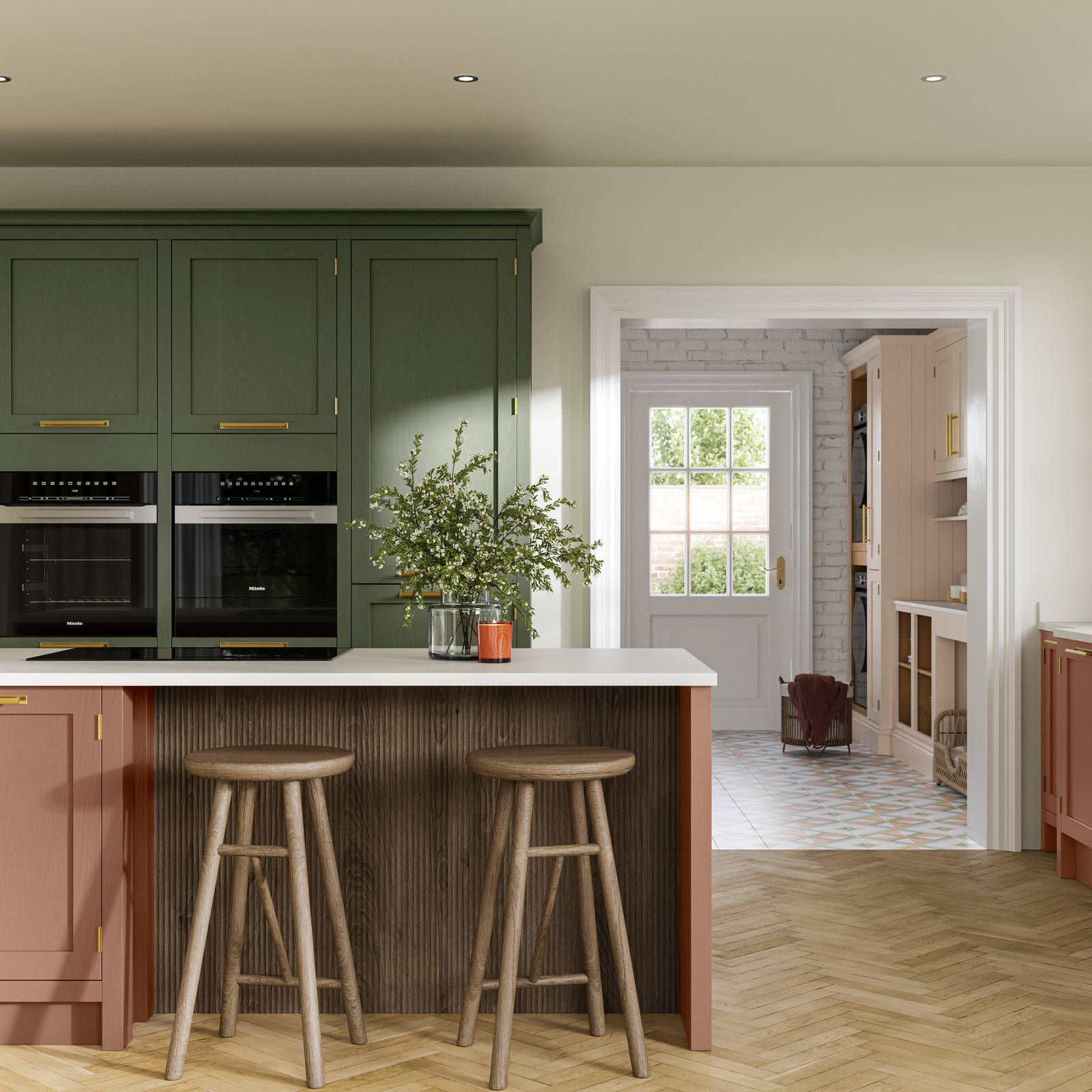 Tall Wardley kitchen cabinets  with built-in ovens, a kitchen island in shade Clay with wooden panelling by seating area and matching wooden bar stools.