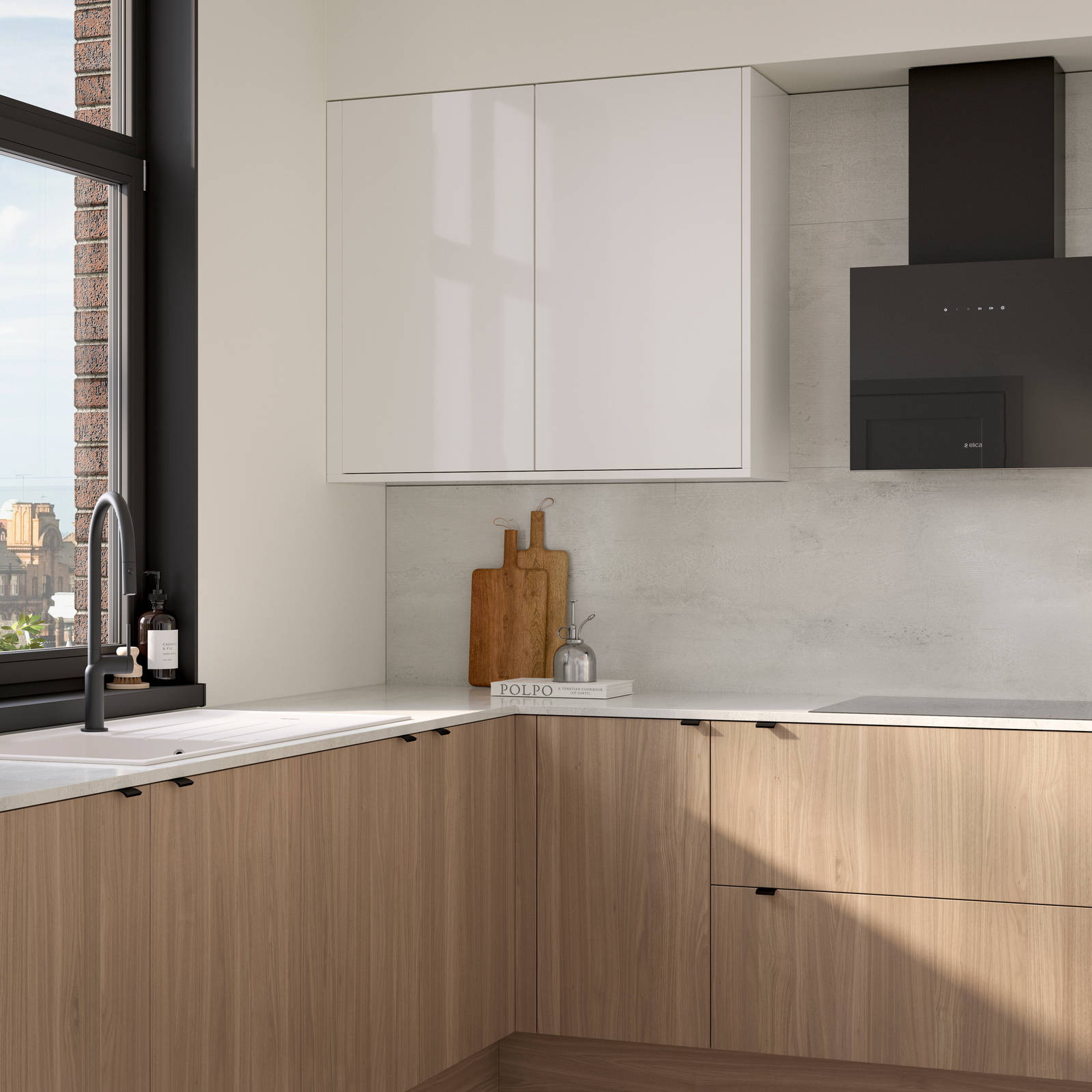 Ascoli kitchen from Magnet with Natural Oak cabinetry, a white worktop, Ascoli Gloss white wall cabinets over countertop paired with matching black handles, tap, hood and window frame over white sink.