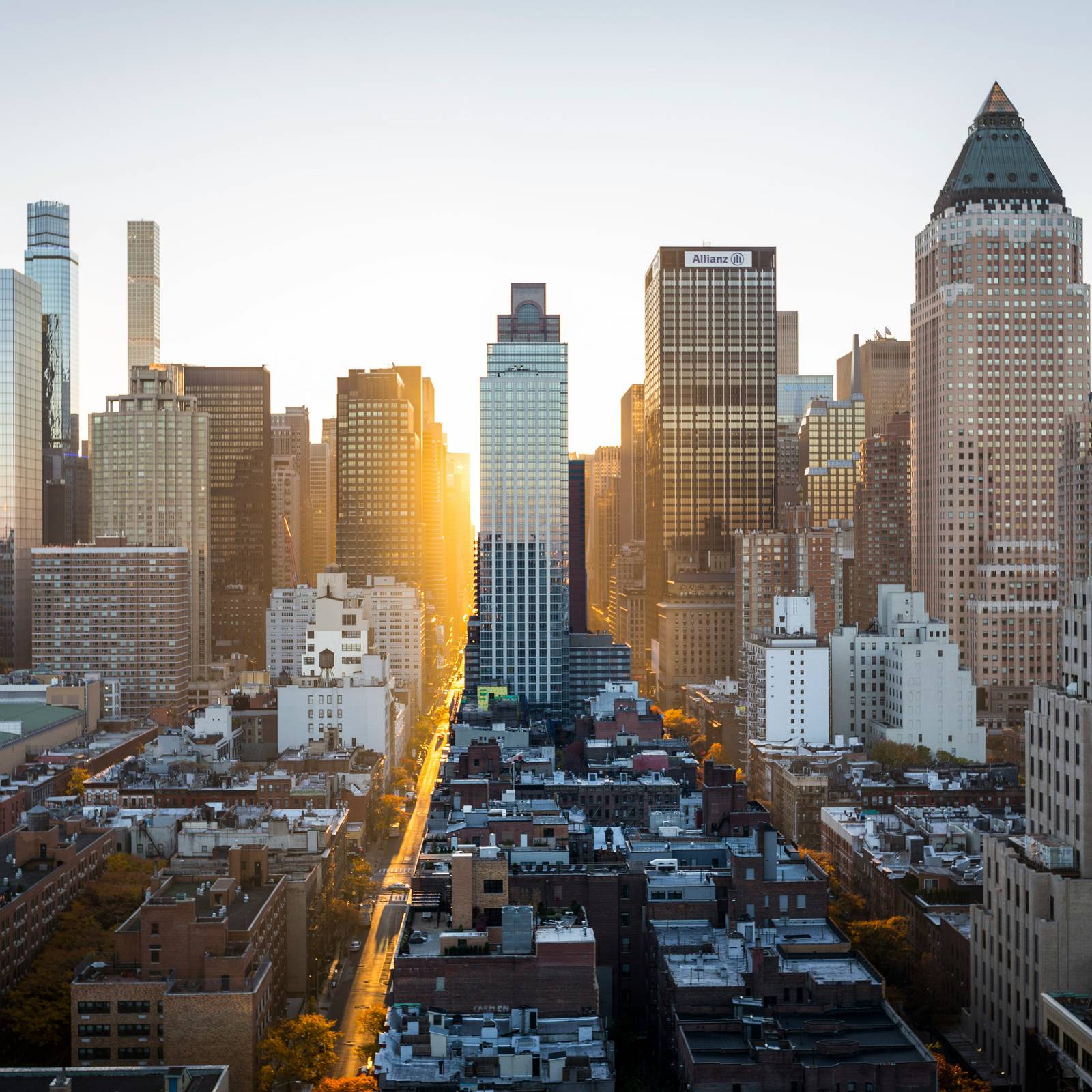 The New York city skyline with a sunset in the background.