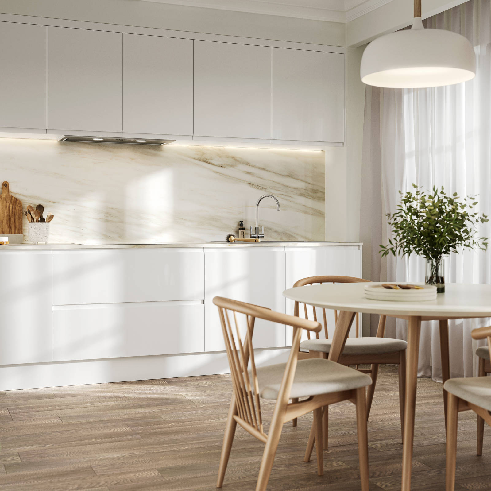 Handleless white gloss Luna kitchen from Magnet, a round wooden kitchen table with matching chairs in foreground