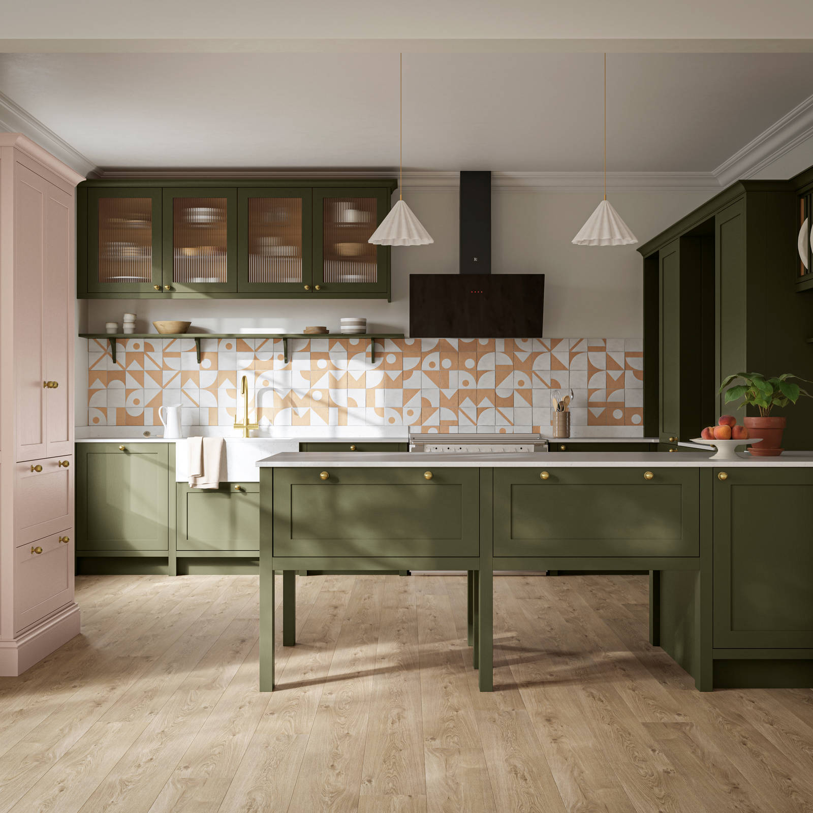 Premium Shaker kitchen Wardley Tailored green with traditional detailing, brass accessories, fluted glass wall vitrine cabinets, standalone Wardley Chalk Blush pantry, Classic Flint Grey oiled oak engineered wood flooring.