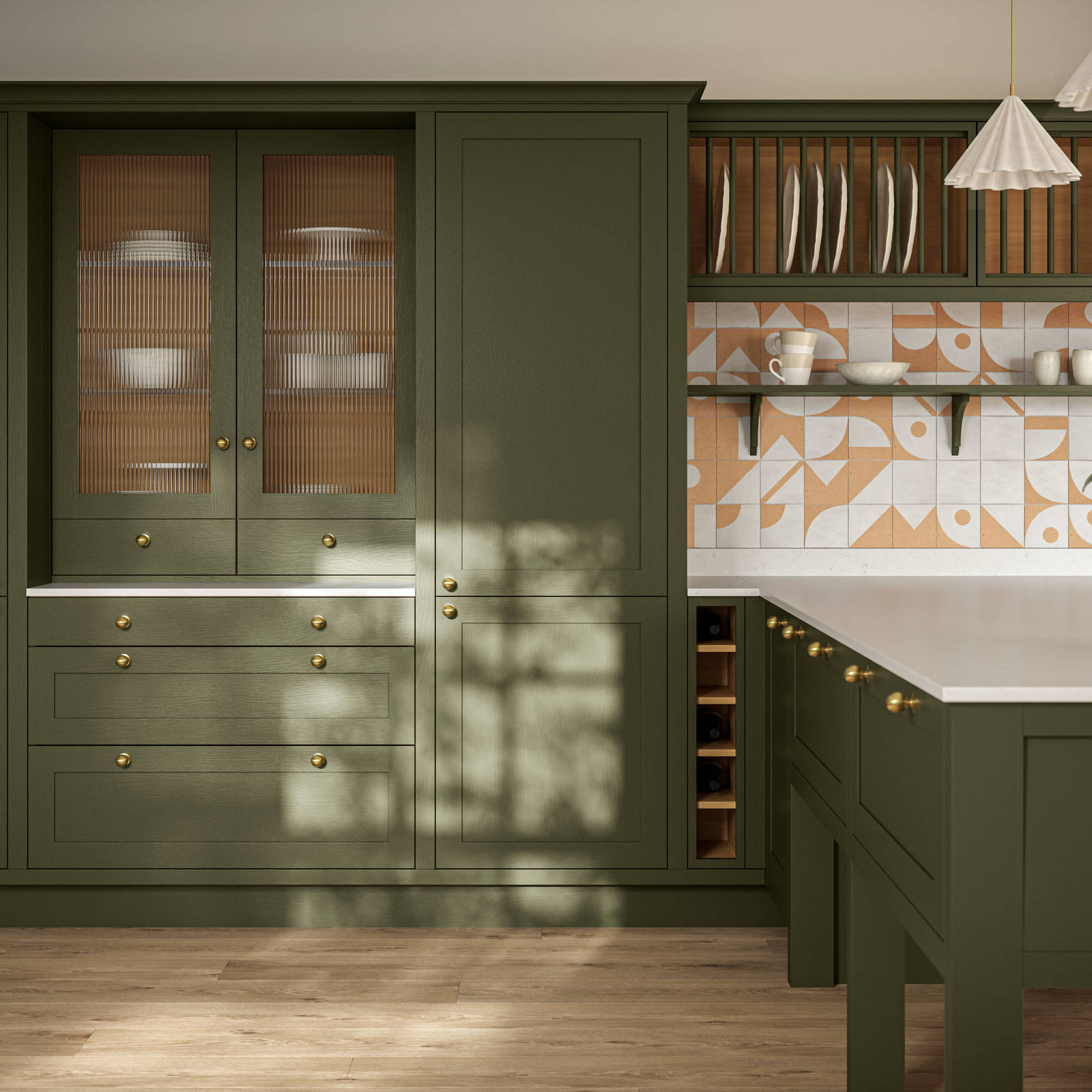 Premium Shaker kitchen Wardley Tailored green with kitchen island, traditional detailing, brass accessories, white worktop and Classic Flint Grey oiled oak engineered wood flooring.