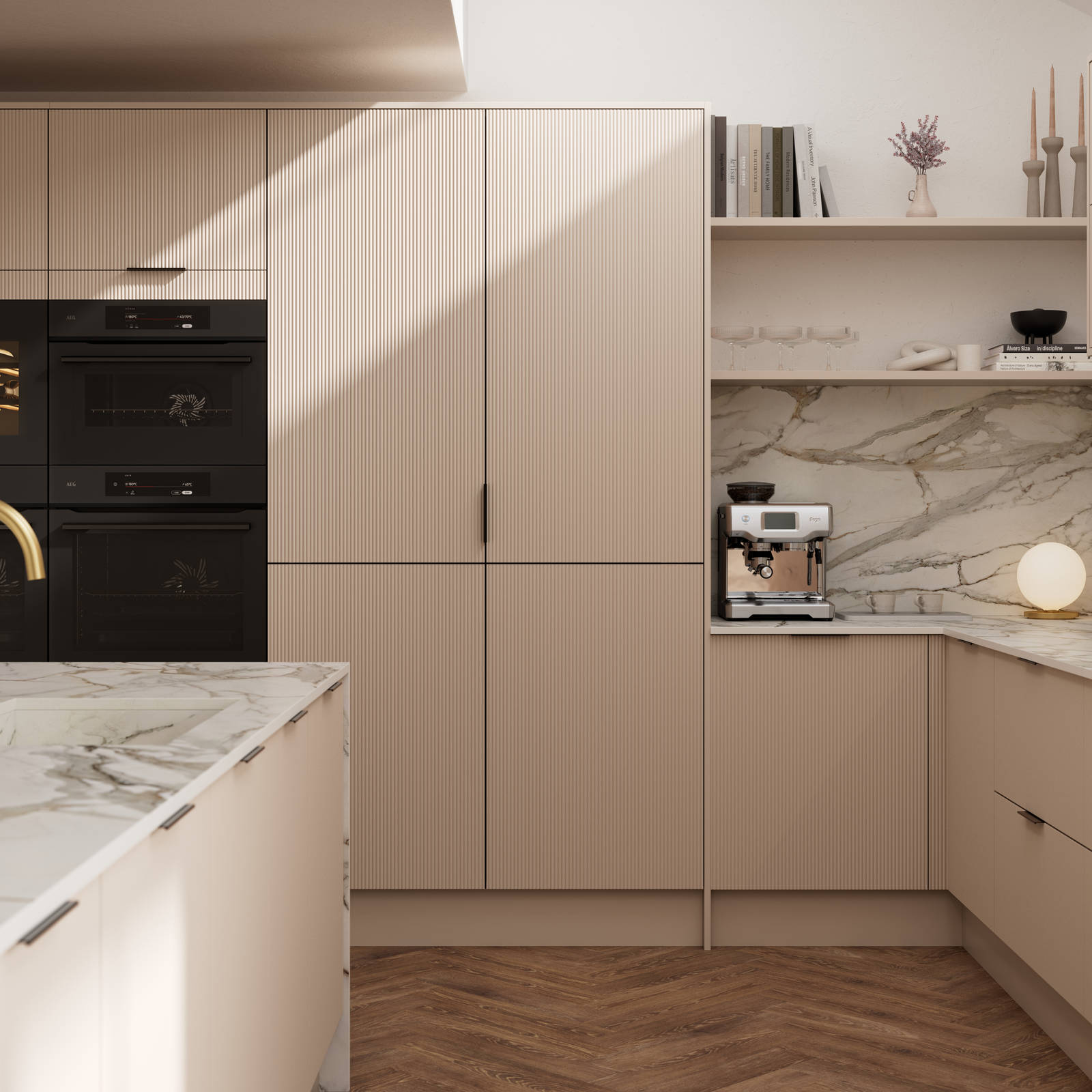 Fluted front kitchen Reed from Magnet in light warm neutral shade Shell, with a marbled splashback and worktop, brass tap in kitchen island sink