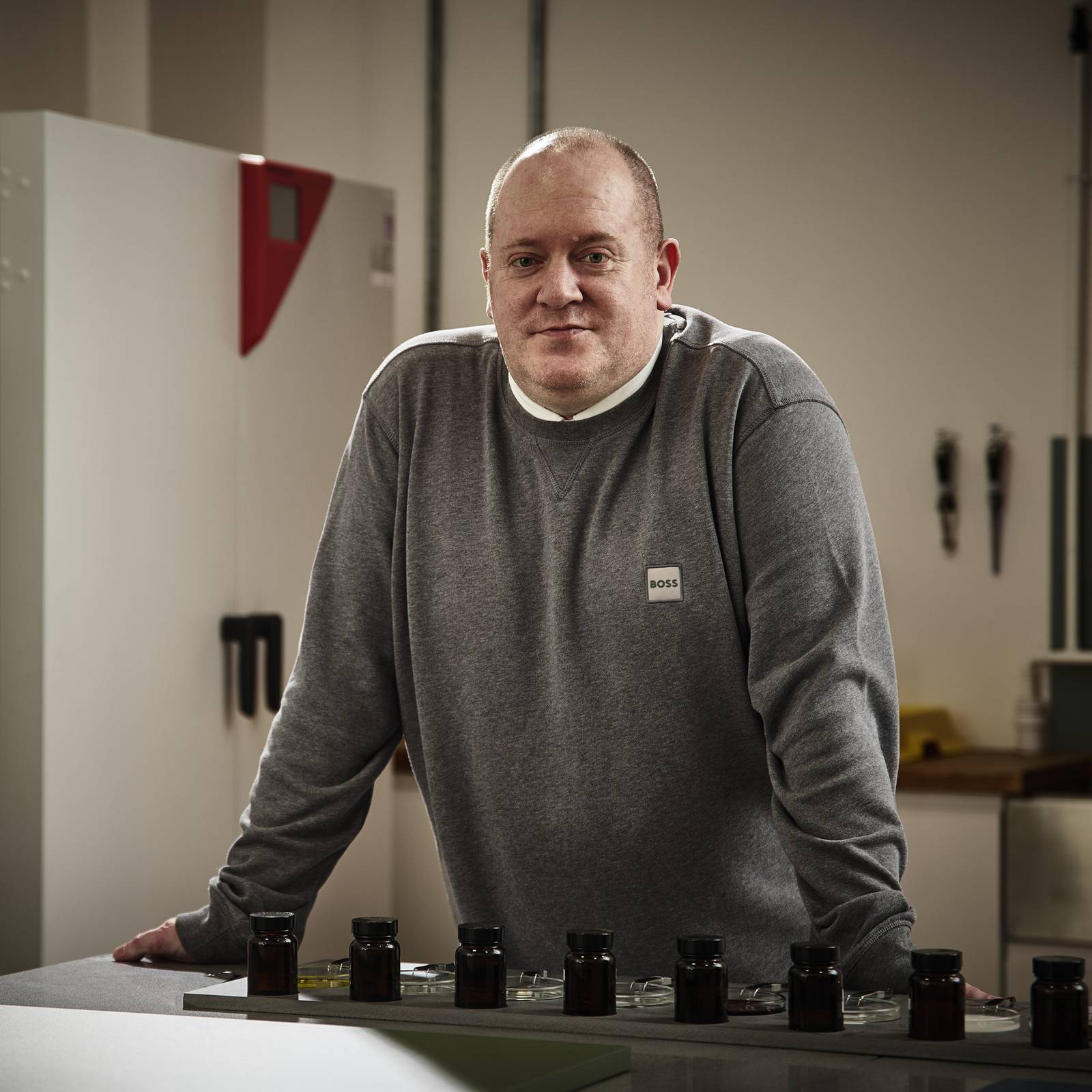 Magnet product expert Charlie Allan, pictured in our kitchen cabinet testing lab, with quality testing equipment and machinery in the background.