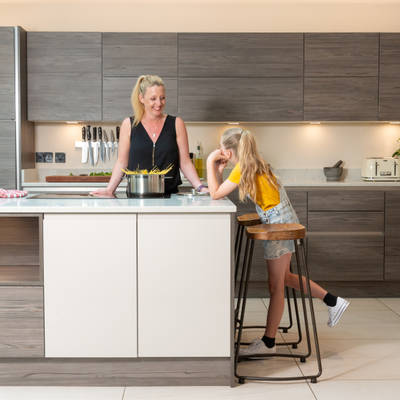 Caroline and her daughter laughing together by the kitchen island