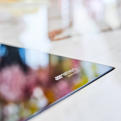 Close-up of Smeg induction logo on Sophie Robinson's Smeg 90 cm induction hob in kitchen island.