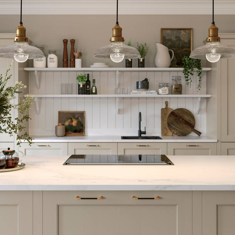 Ludlow kitchen island, a Shaker door with a modern country-style in the neutral shade Pebble path matched with brass details and white open shelves with wall panelling.