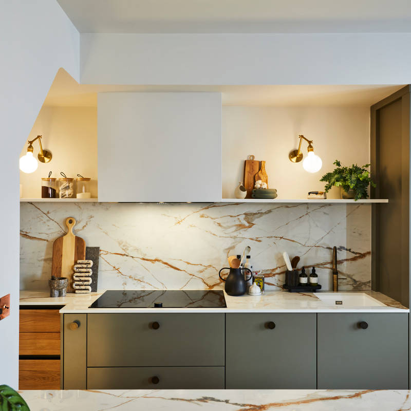 Straight view of modern slab Soho cabinets in the Balmoral colour, paired with a marbled earthy tones Dekton worktop and splashback