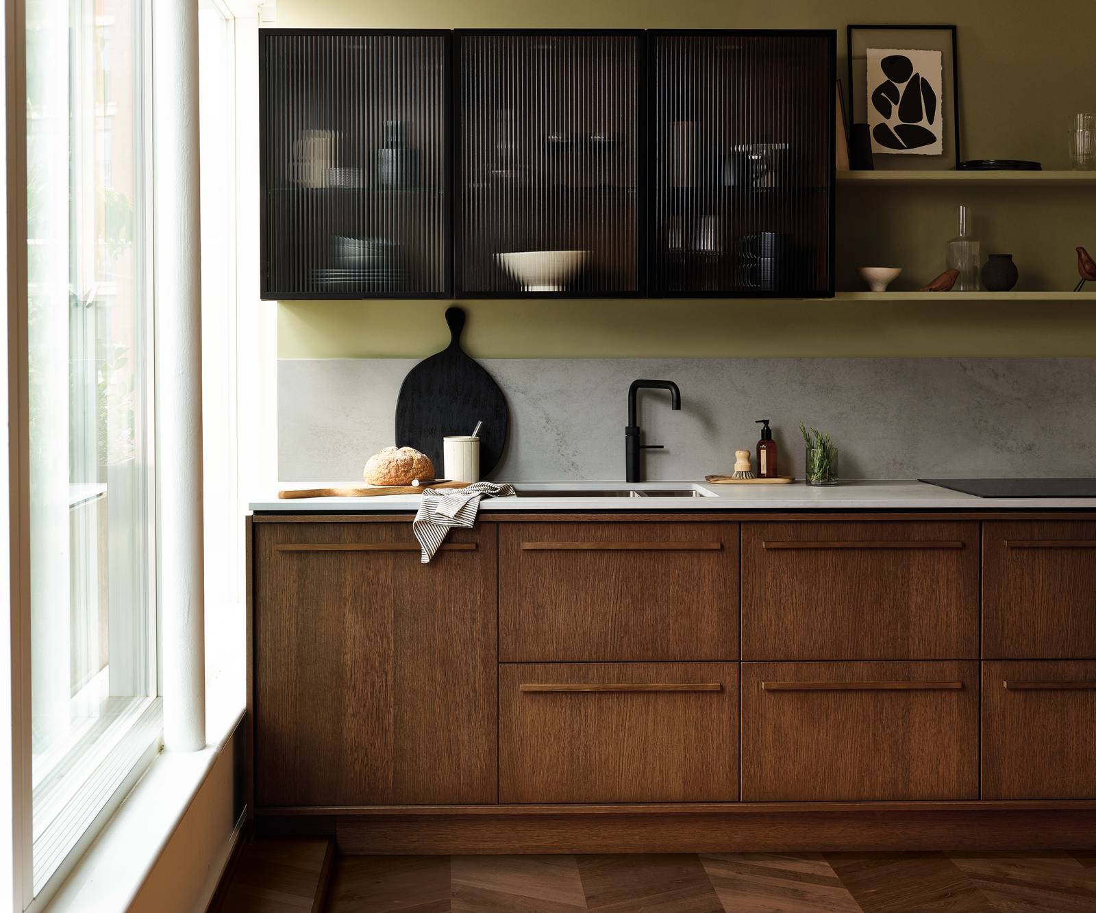 Magnet's kitchen Nordic Nature, with oak cabinetry and display cabinets with fluted glass.