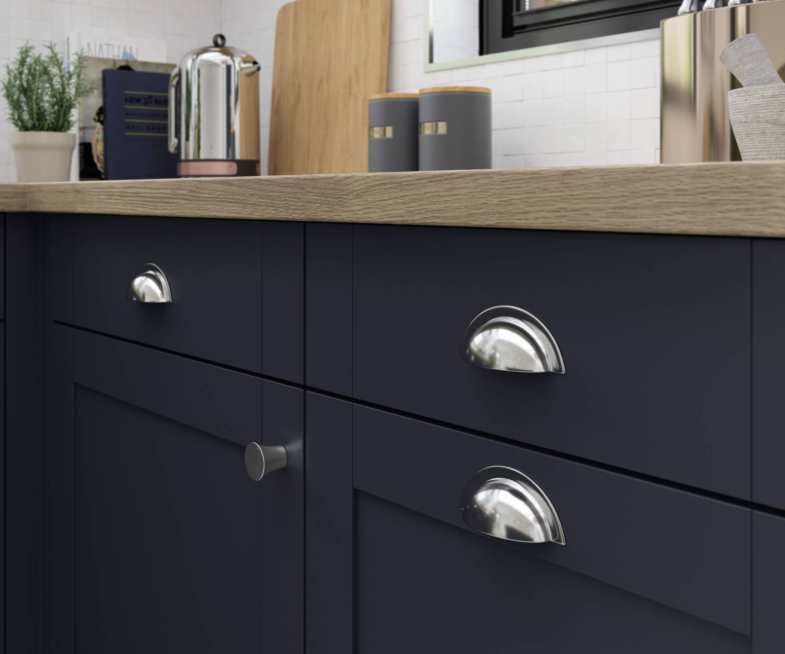 Close-up of Tatton Midnight kitchen from Magnet, a contemporary dark blue narrow frame shaker door, with steel handles and wood worktop.