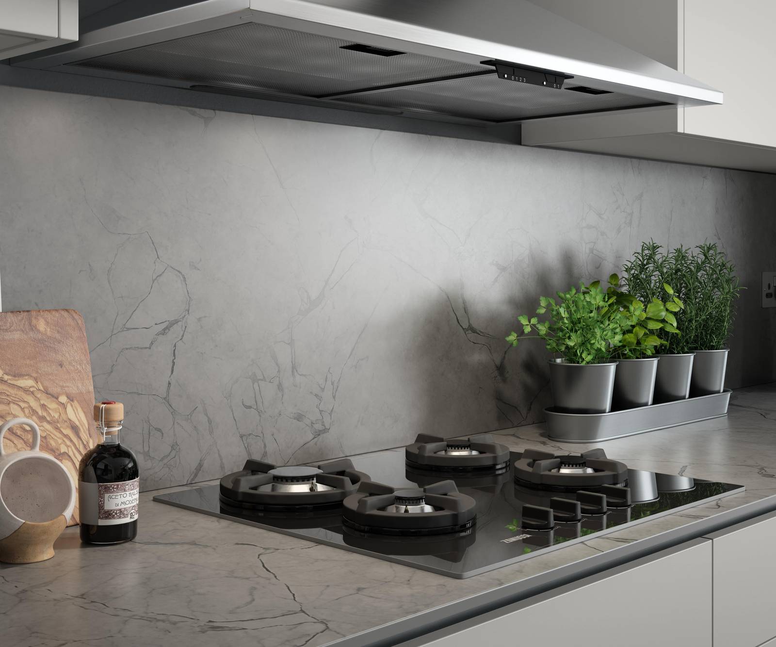 Close-up of hob on a grey and black marbled worktop and splashback in kitchen Integra Nova Grey by Magnet.